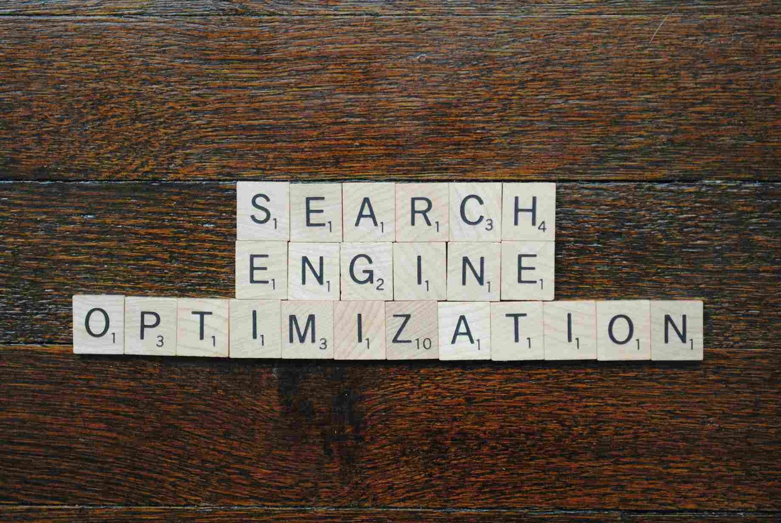 Close-up of wooden Scrabble tiles forming the words Search Engine Optimization, representing SEO and digital website optimization